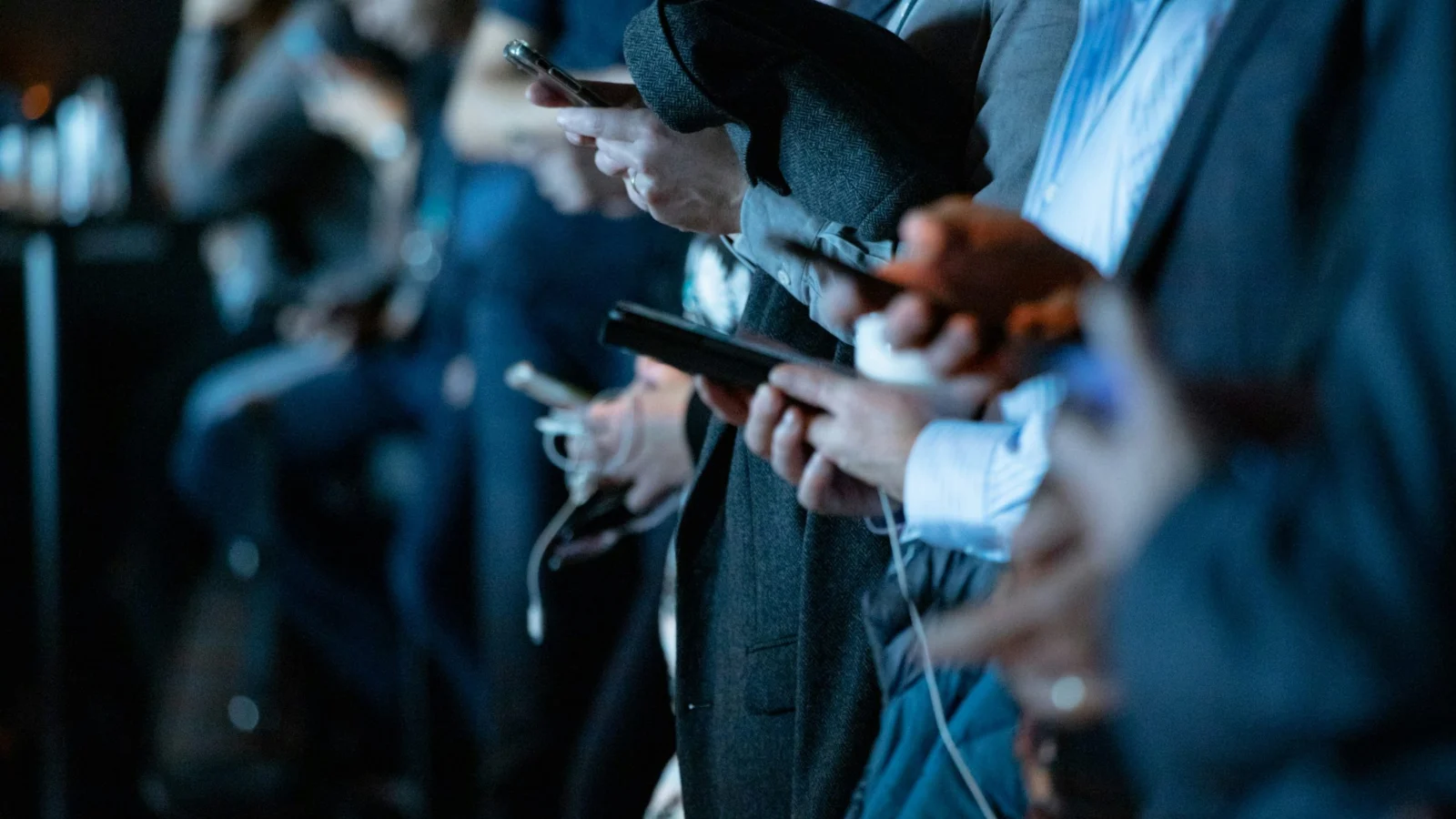 Rows of people looking down at their phones